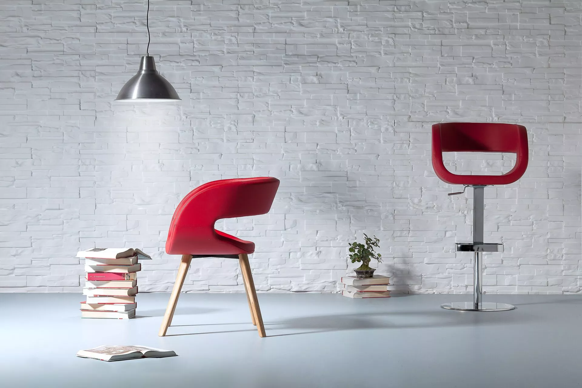 Ego chair by Peressini with a curved, wide shell seat upholstered in smooth fabric and supported by slender metal legs.