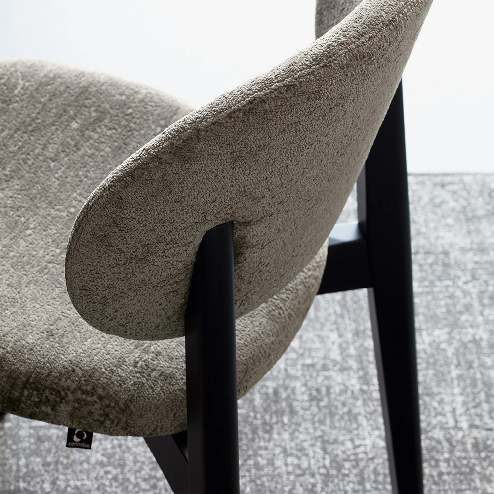 “Side view of Eide Soft by Connubia – contemporary Italian chair with soft padding and minimalist design”