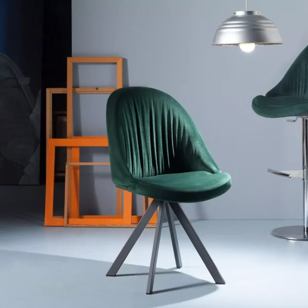Elite chair by Peressini with high backrest and gently reclining upholstered shell on slender metal legs.