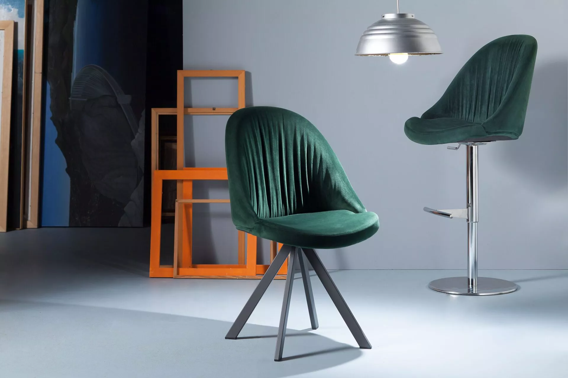 Elite chair by Peressini with high backrest and gently reclining upholstered shell on slender metal legs.