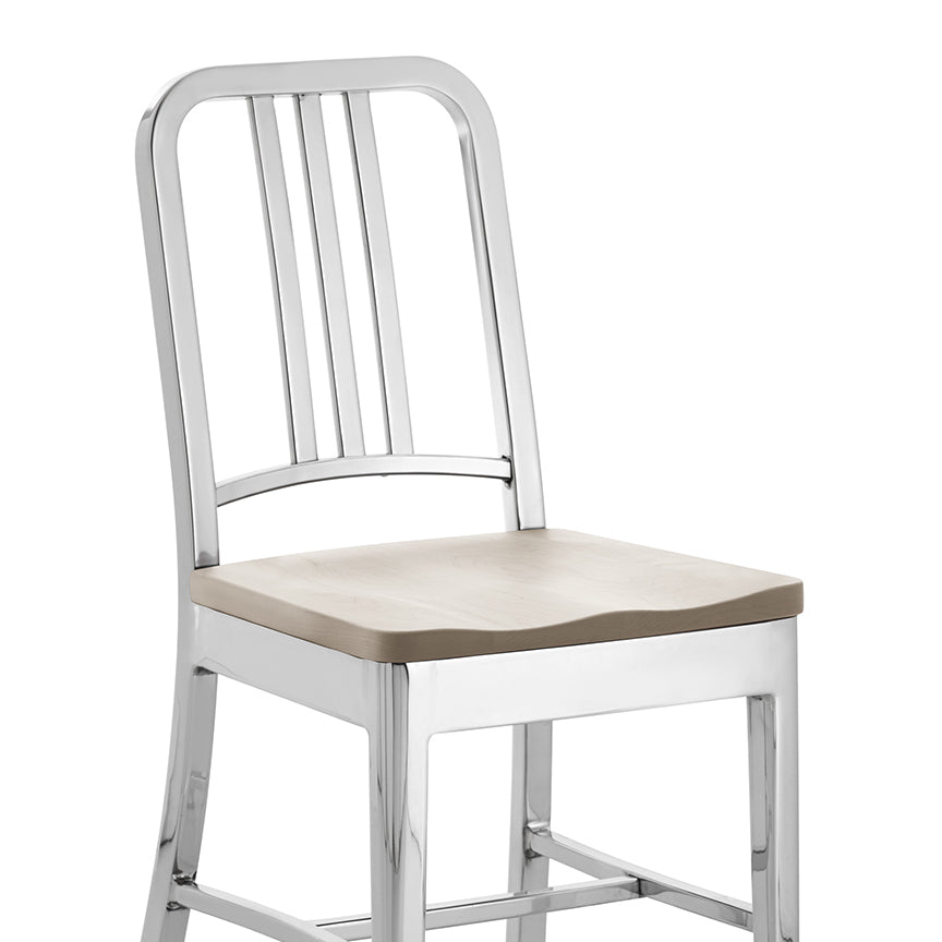 “Warm and durable 1104 Navy Chair® by Emeco, offering a sculptural wooden take on the military original.”