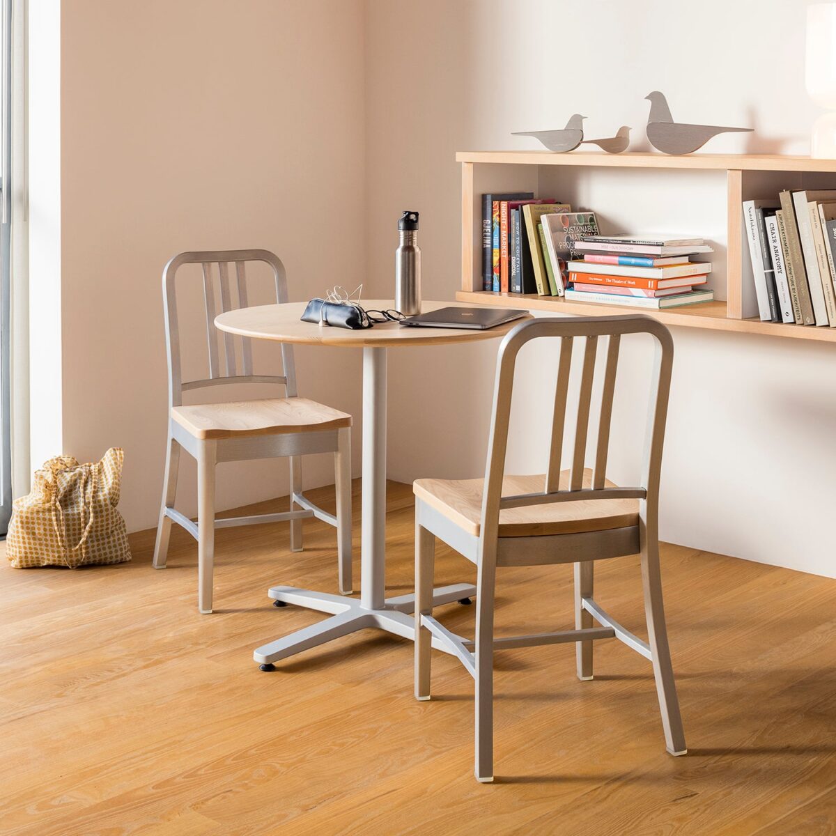 The Emeco 1104 Navy Chair combines a strong aluminum frame with a high-quality black oak seat for lasting durability.