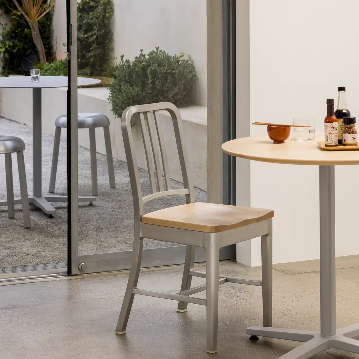 1104 Navy stool with arms by Emeco – modern luxury seating for homes in Royal Oak.