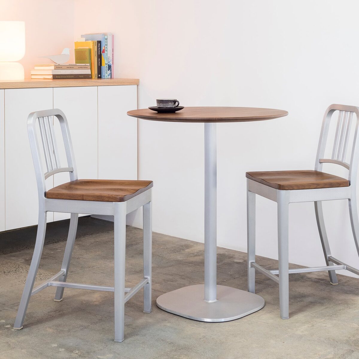 Emeco 1104 Navy Chair with black oak seat and brushed aluminum frame, designed for long-lasting strength and modern appeal.