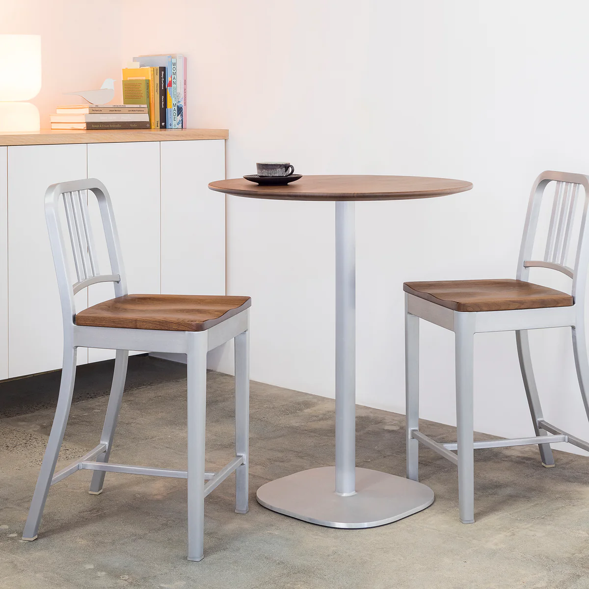1104 Navy Stool with hand-polished walnut seat by Emeco, designed by Philippe Starck, features a recycled aluminum frame with a polished finish and a handcrafted solid walnut seat, suitable for both residential and commercial spaces.