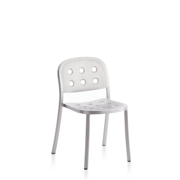 Sleek aluminum chair with perforated seat and backrest, designed by Jasper Morrison, offering a modern industrial aesthetic for both indoor and outdoor use.