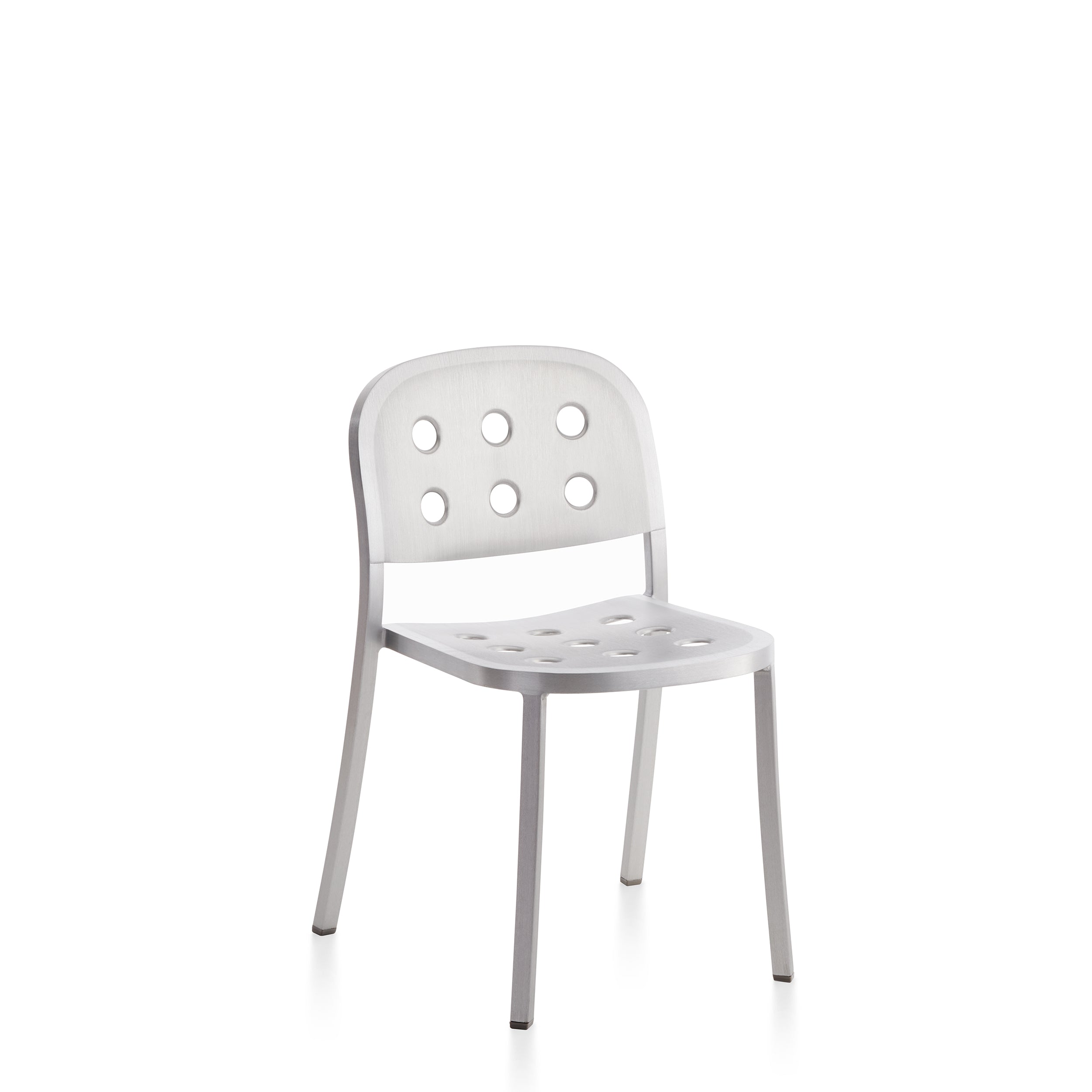 Sleek aluminum chair with perforated seat and backrest, designed by Jasper Morrison, offering a modern industrial aesthetic for both indoor and outdoor use.