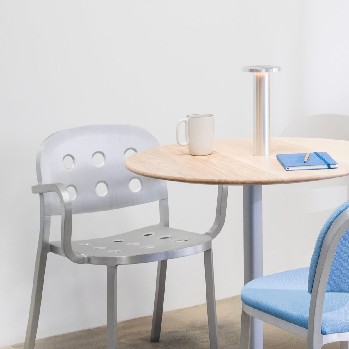 Stylish 1-inch thick aluminum chair by Jasper Morrison, featuring a minimalist design with perforations, perfect for modern spaces and eco-conscious settings.