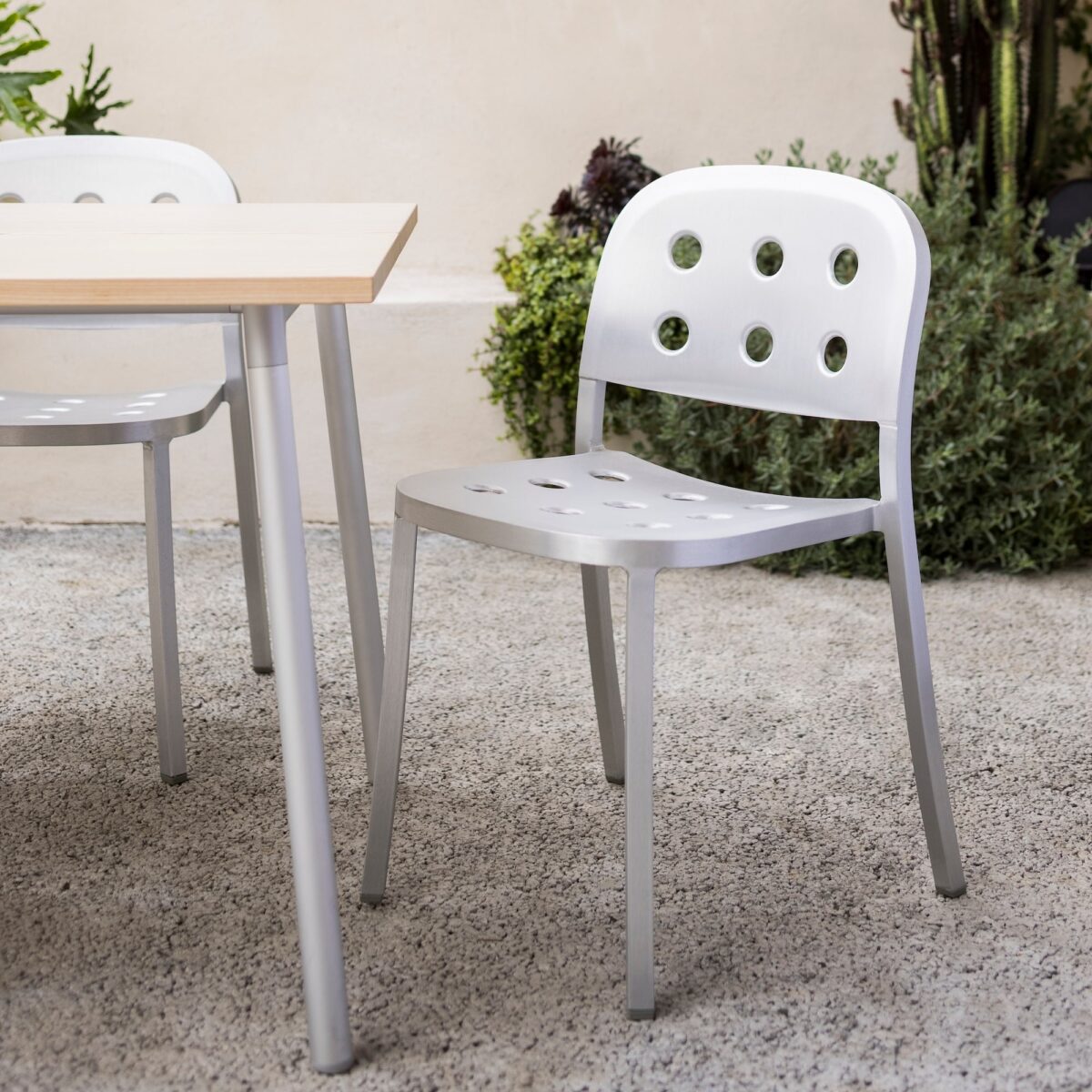 Emeco’s 1 Inch All Aluminum Chair, designed by Jasper Morrison, features a stackable design with perforated aluminum for comfort and style in contemporary spaces.