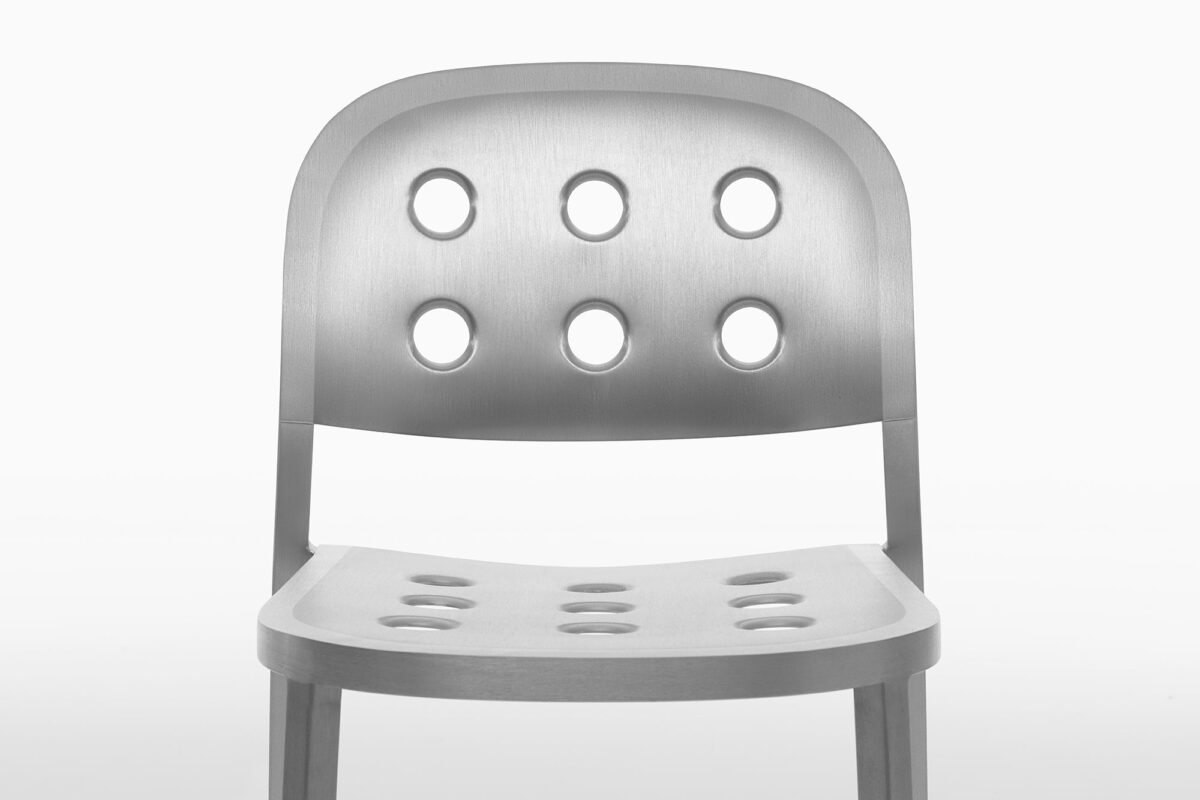 Minimalist chair designed by Jasper Morrison, made from lightweight aluminum with a perforated seat and back, adding a touch of industrial elegance to any space.