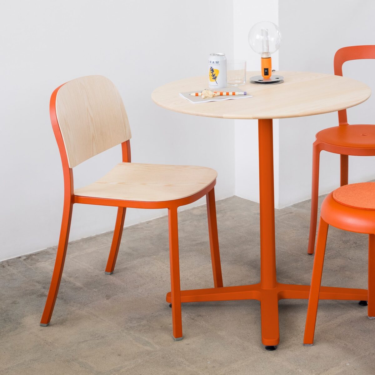 Emeco 1 Inch side chair, featuring a sleek wood seat design.