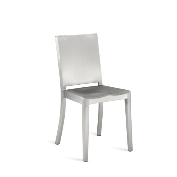 Philippe Starck's Hudson Chair by Emeco, a minimalist masterpiece featuring an industrial aluminum frame, designed for both style and durability.