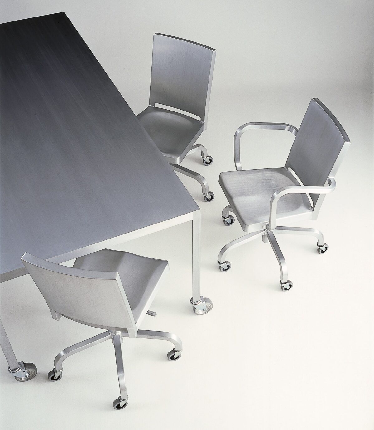 Emeco's Hudson Swivel Chair by Philippe Starck, designed for comfort and style with smooth caster wheels.