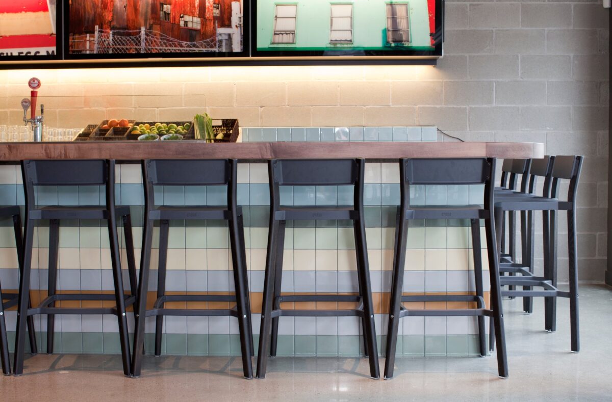 Lancaster Stool by Emeco – High-quality aluminum and dark ash wood construction for a minimalist, durable seating option.