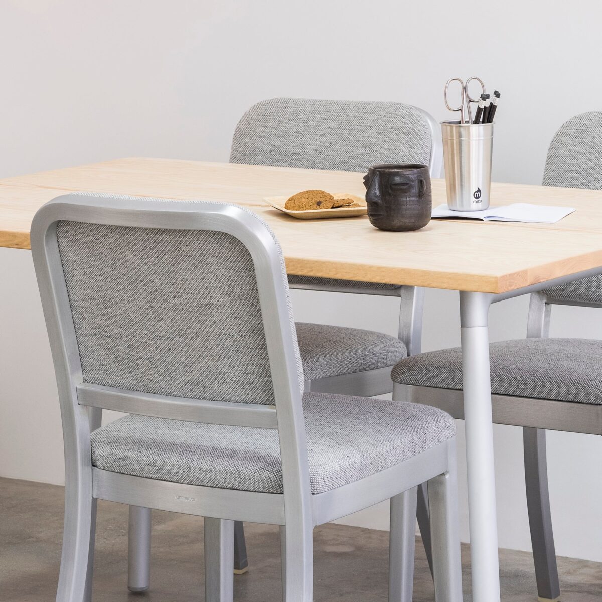 Navy Officer Side Chair with modern silhouette and durable material by Emeco.