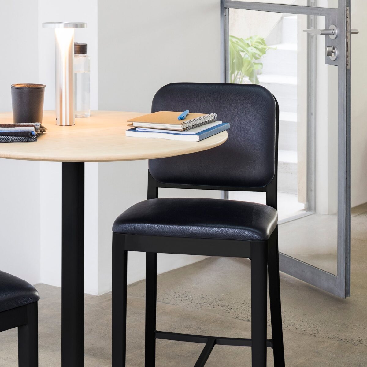 “High Navy Officer Stool by Emeco crafted from recycled aluminum and premium upholstery.”
