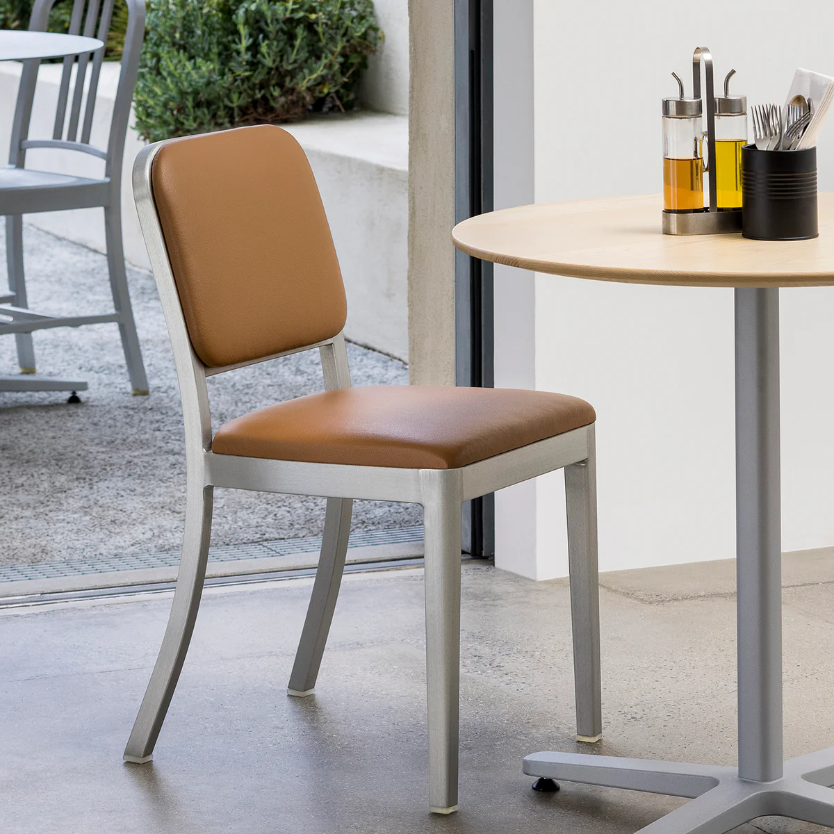 Navy Officer Armchair by Emeco, a stylish and durable design with comfortable armrests, perfect for adding a touch of classic elegance to modern interiors and office spaces.