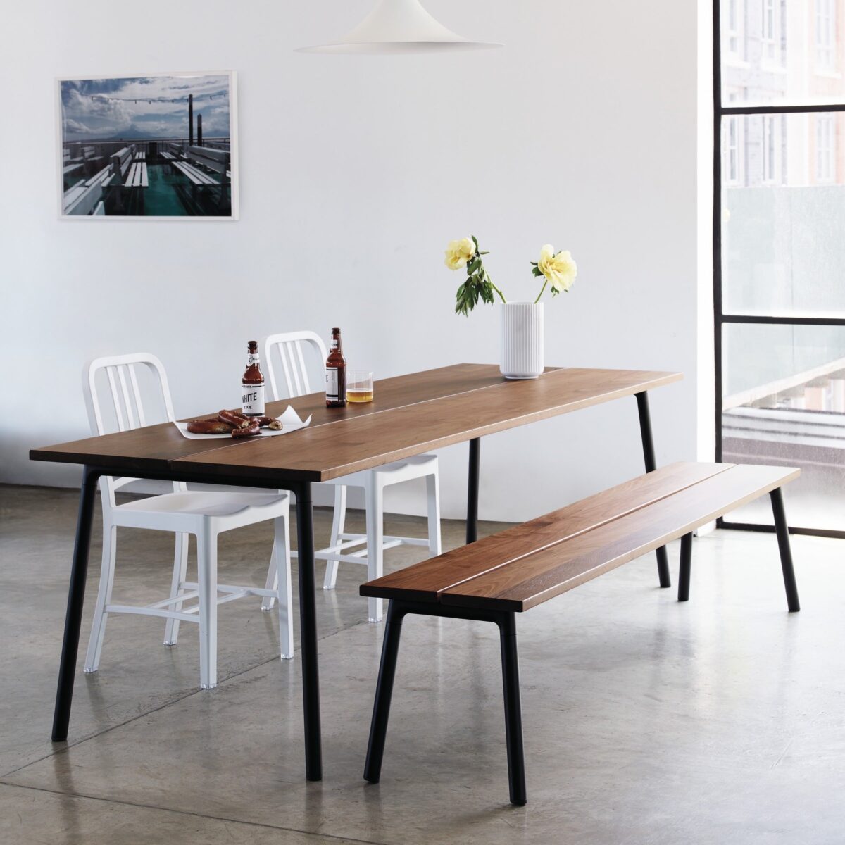 Emeco Run Bench, designed by Hecht and Colin, with a walnut seat and sleek aluminum frame.