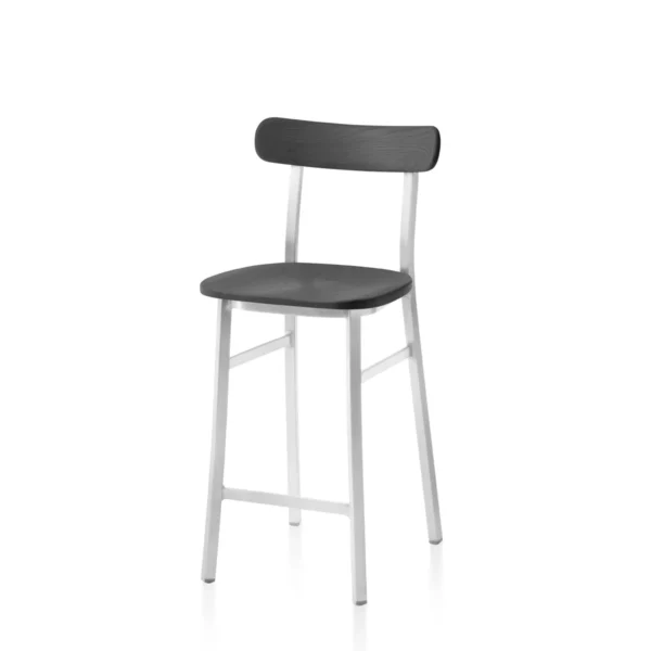 Utility stool with black powder-coated aluminum frame and dark-stained ash seat by Emeco, designed by Jasper Morrison, suitable for both indoor and outdoor use.