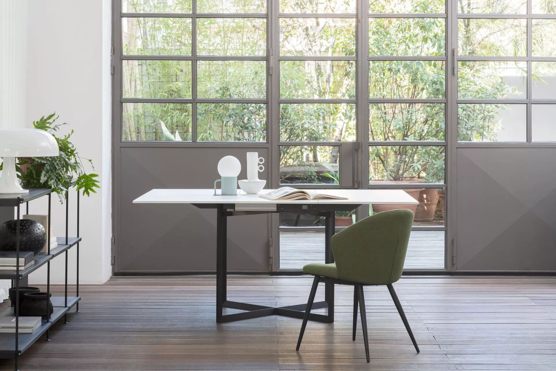 Esprit V chair by Peressini with gently curved backrest and slender metal legs, upholstered in light grey fabric.
