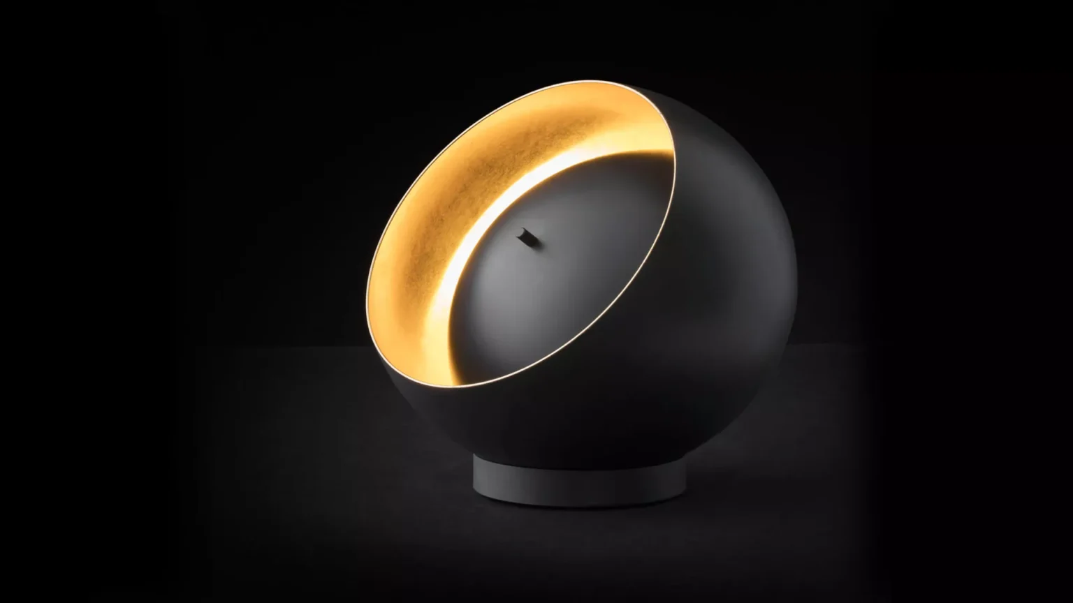“Eva by Oluce modern Italian table lamp – sleek dome-shaped glass diffuser with minimalist metal base”