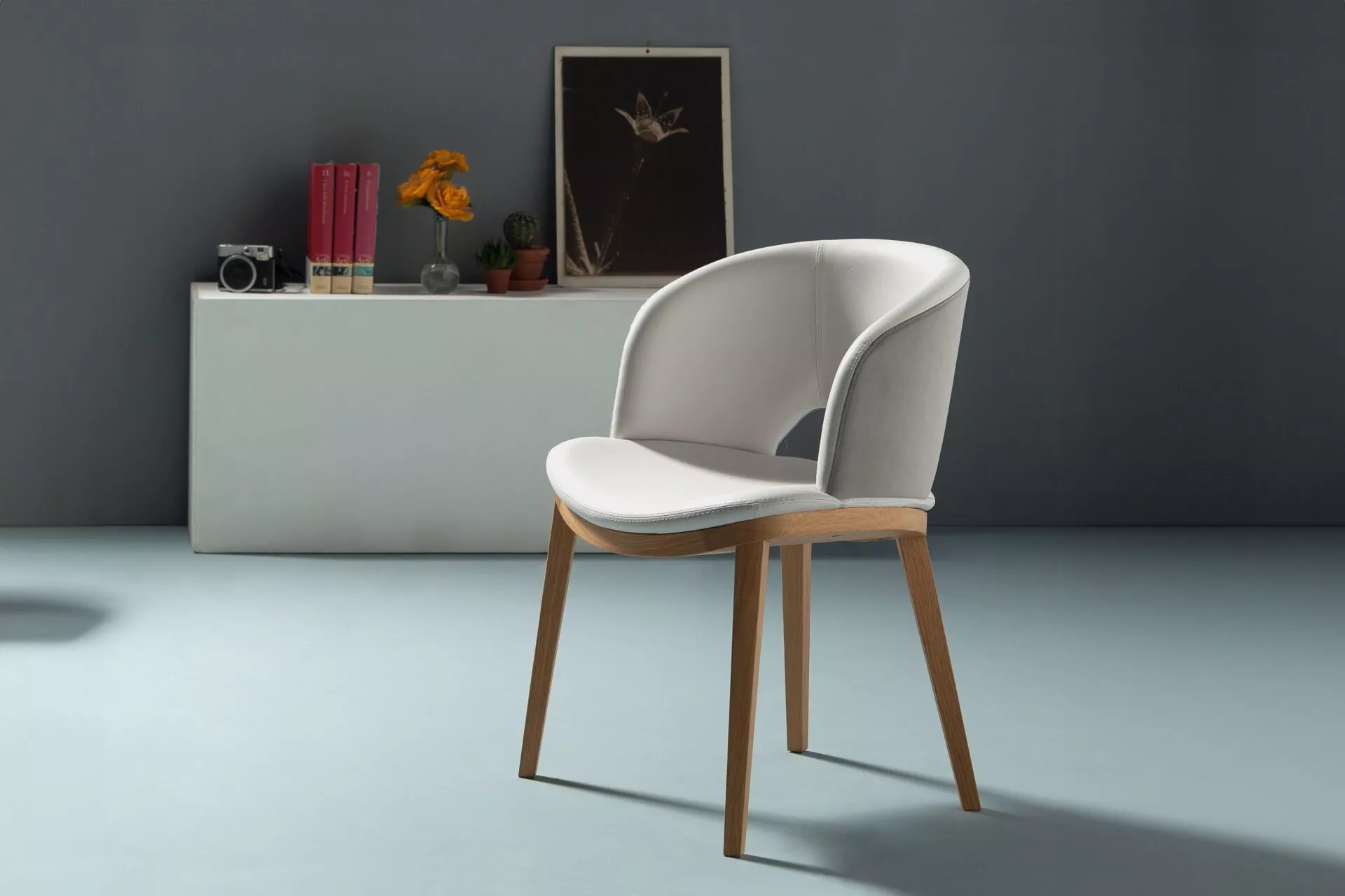 Fashion Q barstool in elegant off-white faux-leather with quilted back detail, standing on a satin steel round pedestal with gas-lift and footrest.