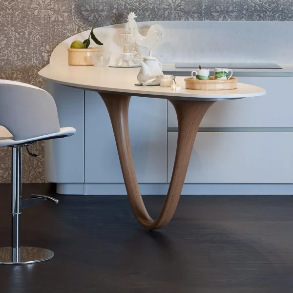 Fashion chair by Peressini Casa upholstered in soft grey fabric with a curved plywood shell and polished chrome sled base, photographed in a minimalist white studio.