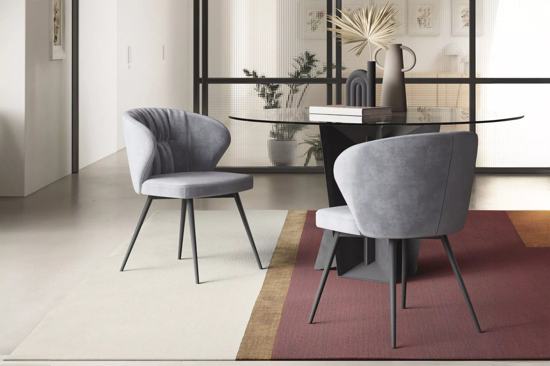 Ingrid chair in powder-blue velvet with gently flared armrest wings, standing on slender black metal legs on a pale wood floor.