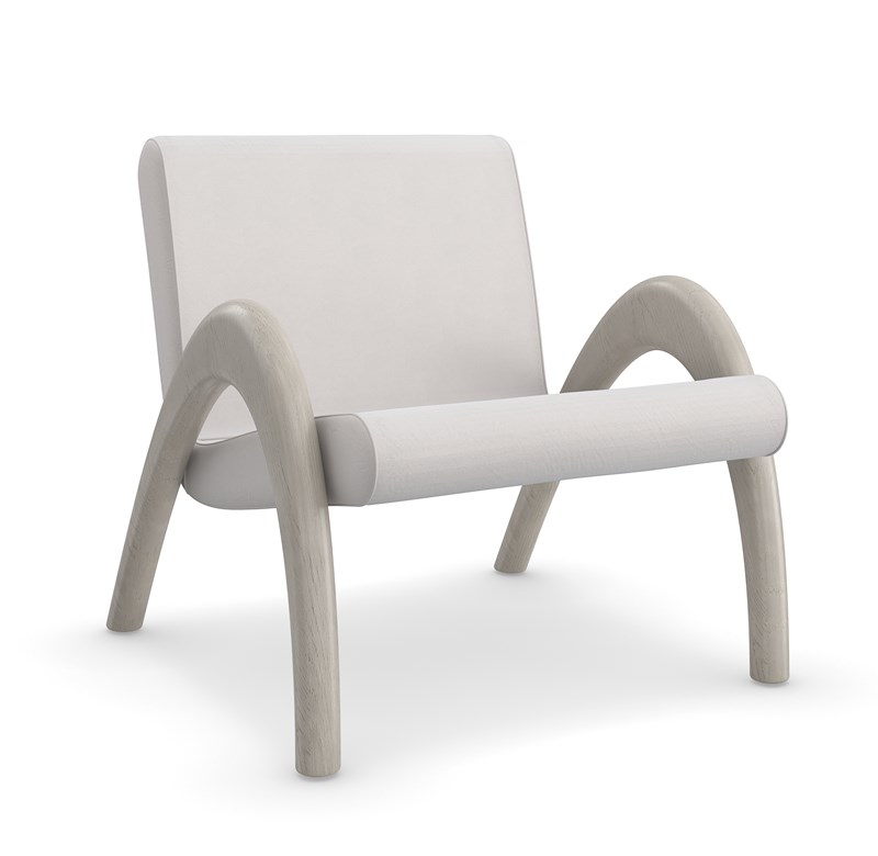 Coco Accent Chair by Caracole featuring a curved ash wood frame in Fossil finish, upholstered in taupe Performance velvet, with a minimalist design and fluid lines, ideal for modern interiors.