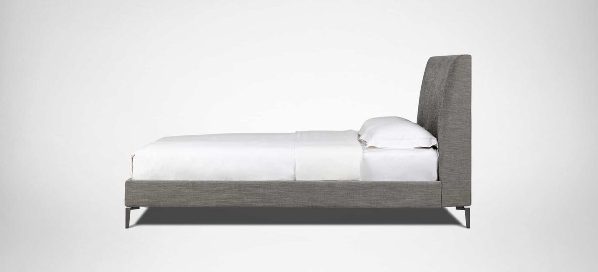 Elegant upholstered bed with curved headboard and minimalist design by Camerich.