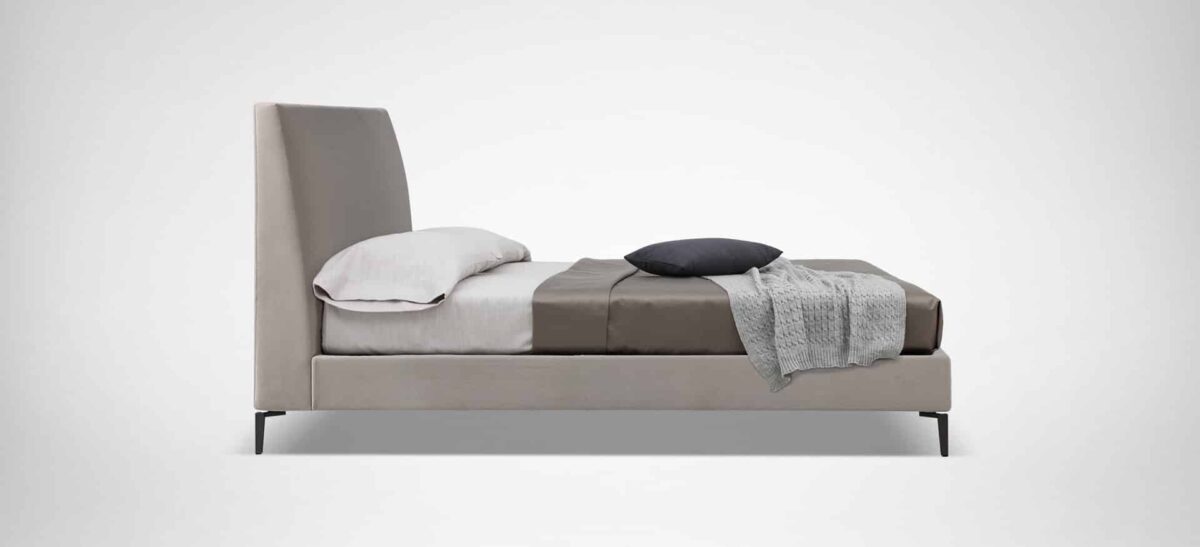 Elegant upholstered bed with curved headboard and minimalist design by Camerich.