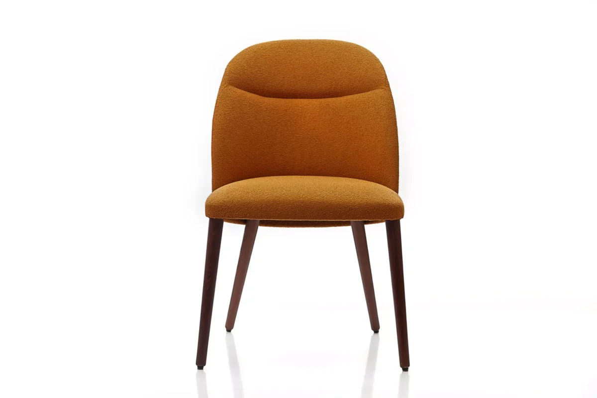 Lady chair by Peressini with a gently reclined backrest, fully upholstered seat, and slender metal legs in matte black.