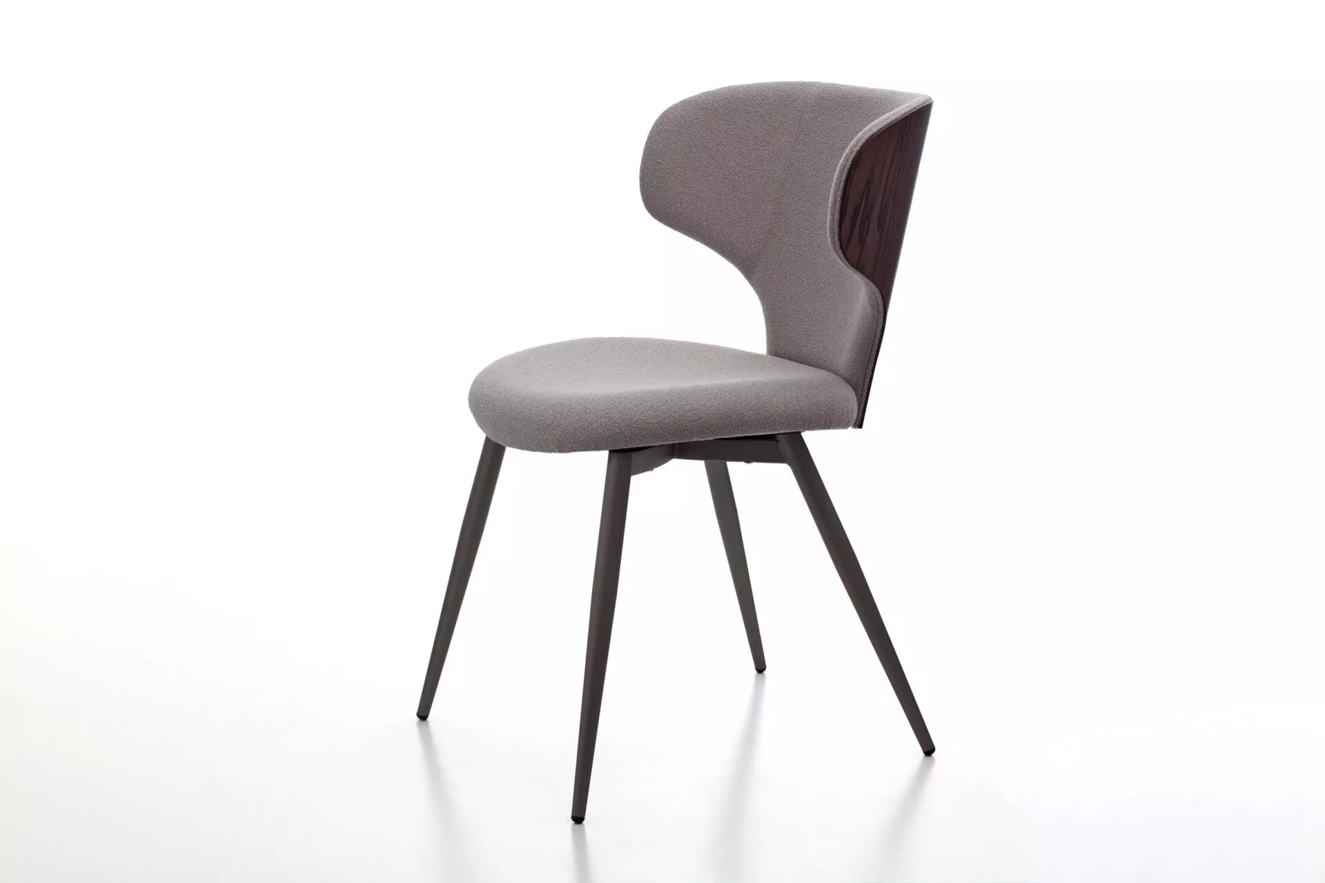 Luna W stool in beige fabric with gently curved backrest, cast‑iron gas‑lift column, and square stainless‑steel base on a showroom floor.