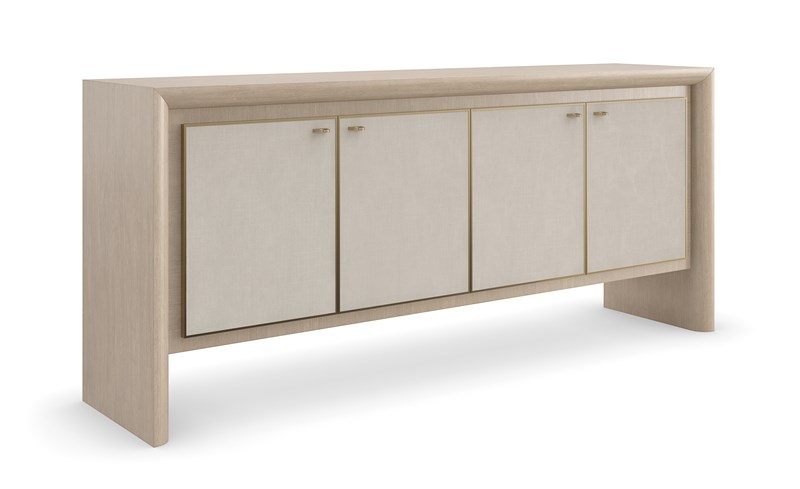 Unity Credenza by Caracole — a sleek storage piece with a sculpted front and metallic accents.