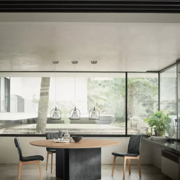 Elegant Magnum dining table by Bontempi in walnut veneer and sleek white concrete base in a modern living space.