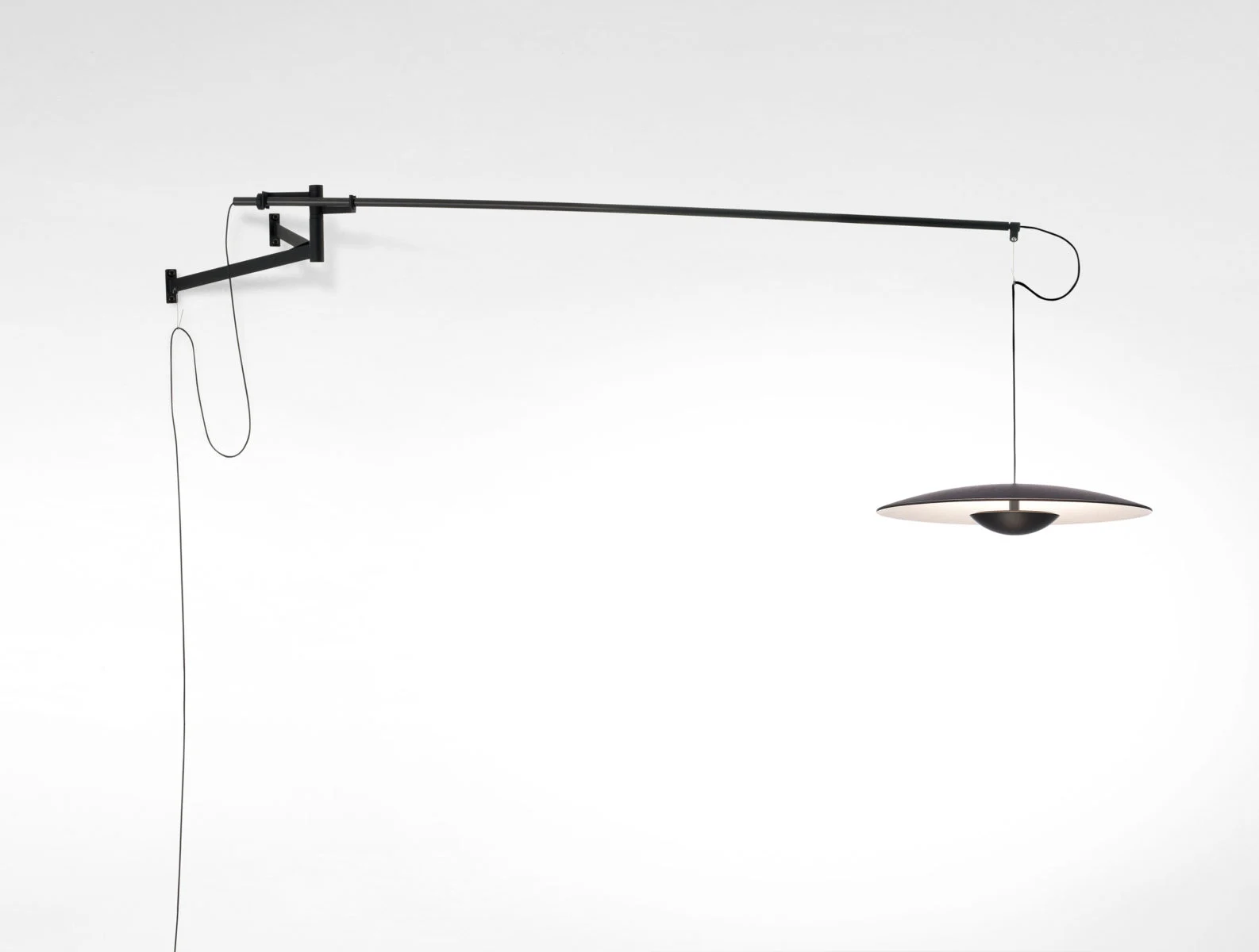 “Modern pendant light Ginger by Marset – sleek wooden disc fixture creating soft ambient glow”
