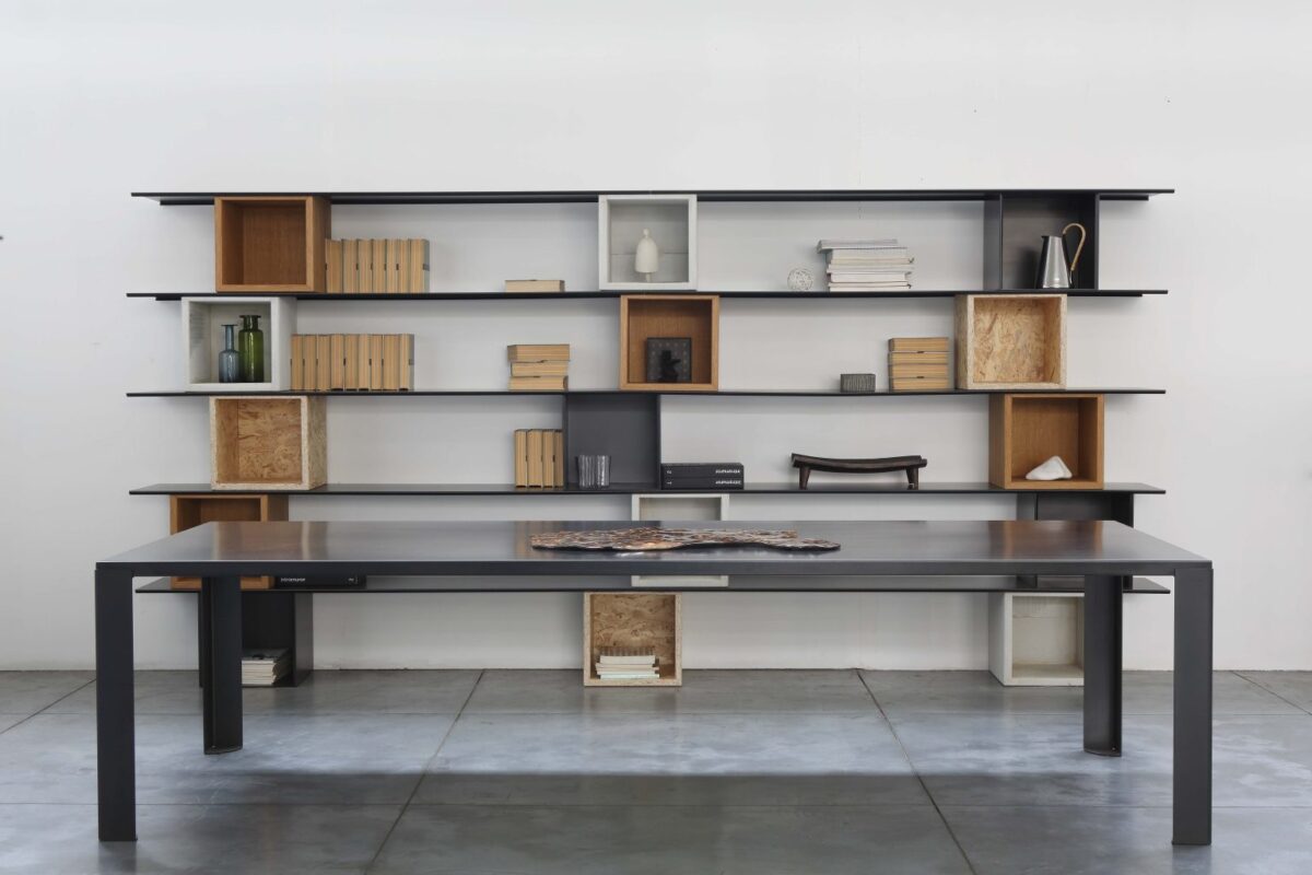 Geometric bookcase with bold steel structure by Zeusnoto.