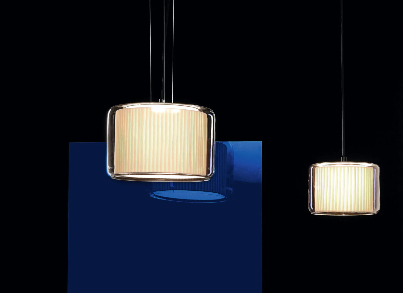 “Contemporary Mercer by Marset table light combining warm textile shade with clear glass design”