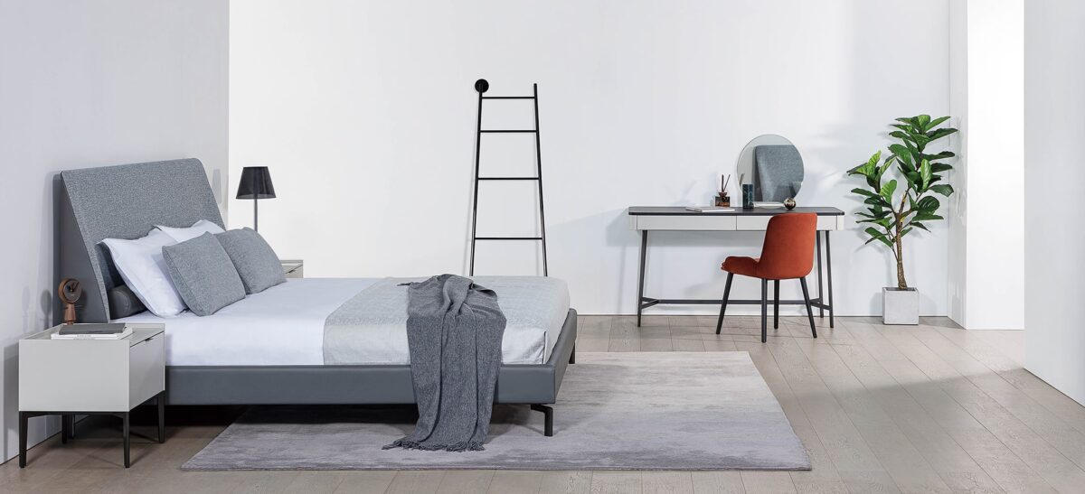 Sleek upholstered bed with soft lines and elegant frame by Camerich.