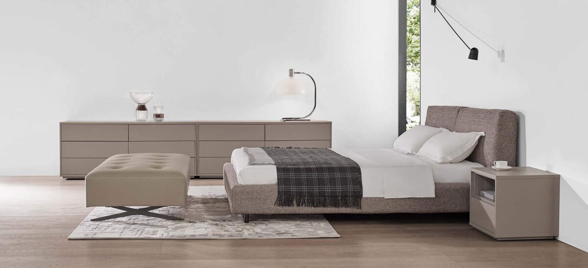 Organic-style bed with natural wood frame and soft upholstered headboard by Camerich.