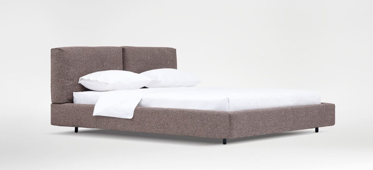 Organic-style bed with natural wood frame and soft upholstered headboard by Camerich.