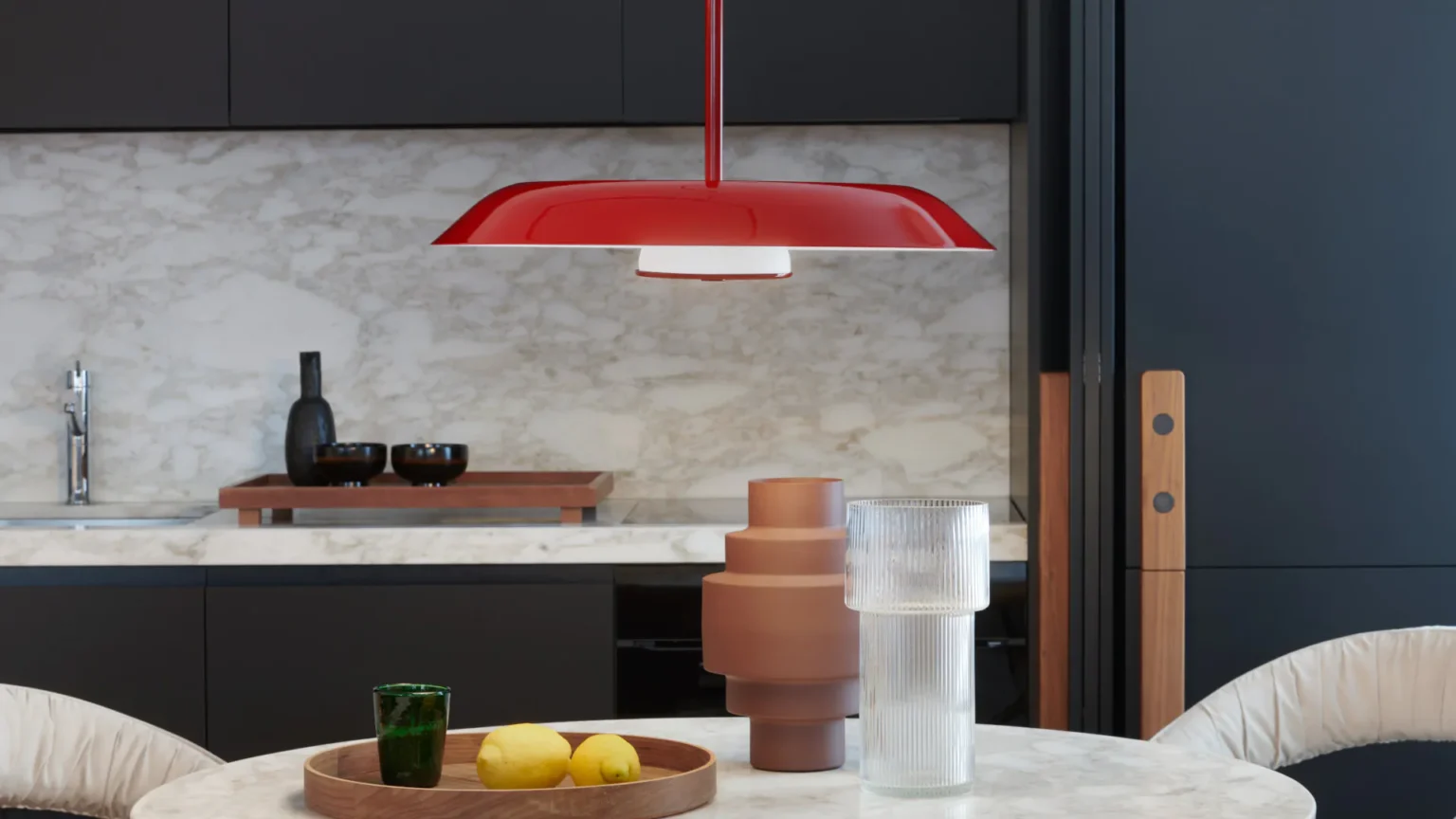 “Iride by Oluce artistic wall light – reflective disc design with minimal mount and glowing inner core”
