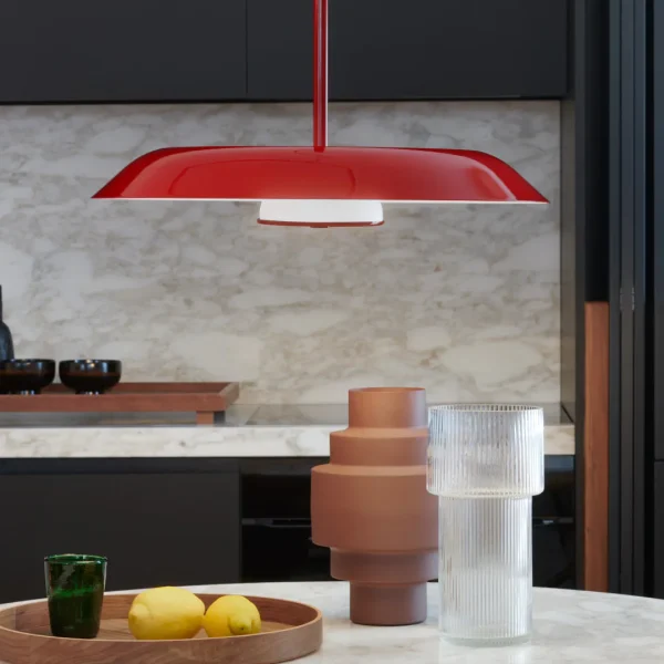 “Iride by Oluce artistic wall light – reflective disc design with minimal mount and glowing inner core”