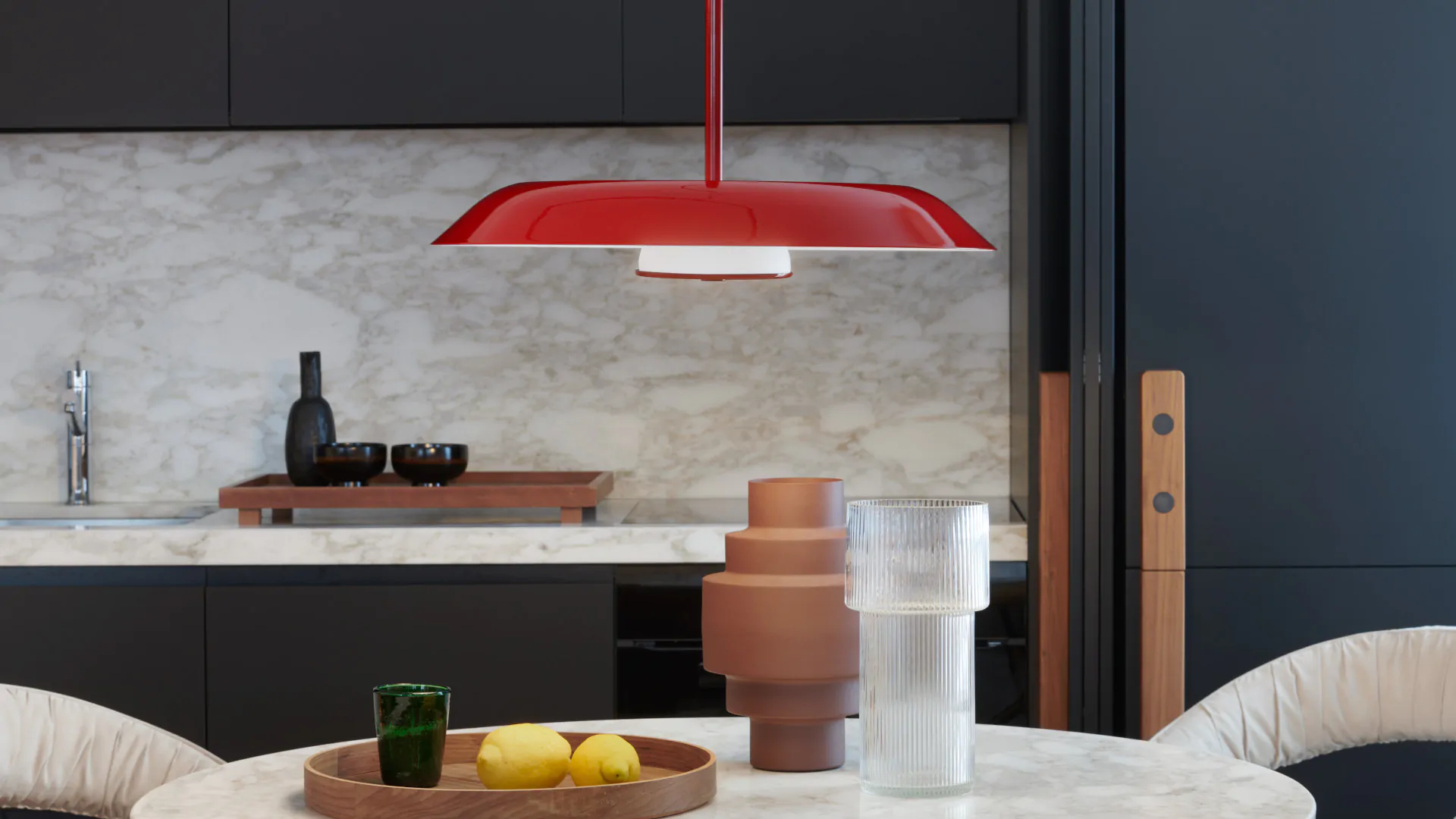 “Iride by Oluce artistic wall light – reflective disc design with minimal mount and glowing inner core”