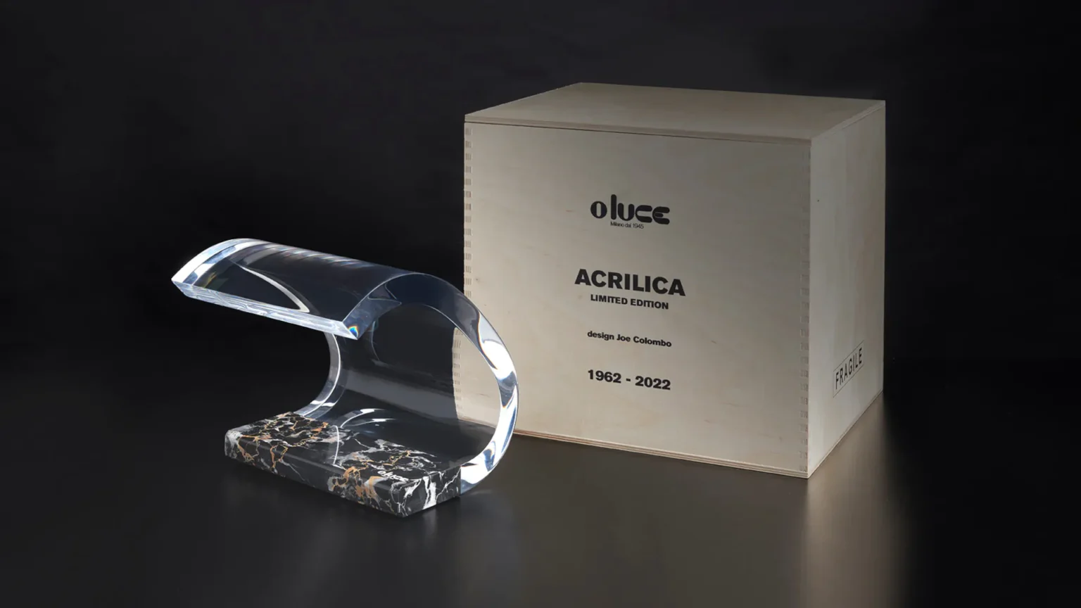“Acrilica by Oluce sculptural designer lamp – contemporary Italian lighting with glowing acrylic arm and minimalist base”