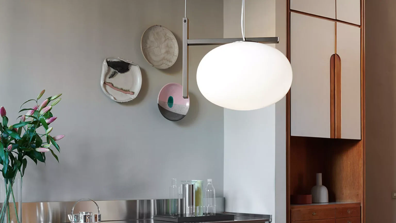 “Alba by Oluce contemporary designer lighting – minimalist floor lamp featuring curved metal arm and glowing glass globe”