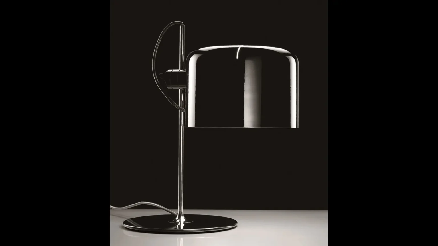 “Coupé by Oluce stylish Italian lamp – compact sculptural table lamp with refined craftsmanship and soft illumination”
