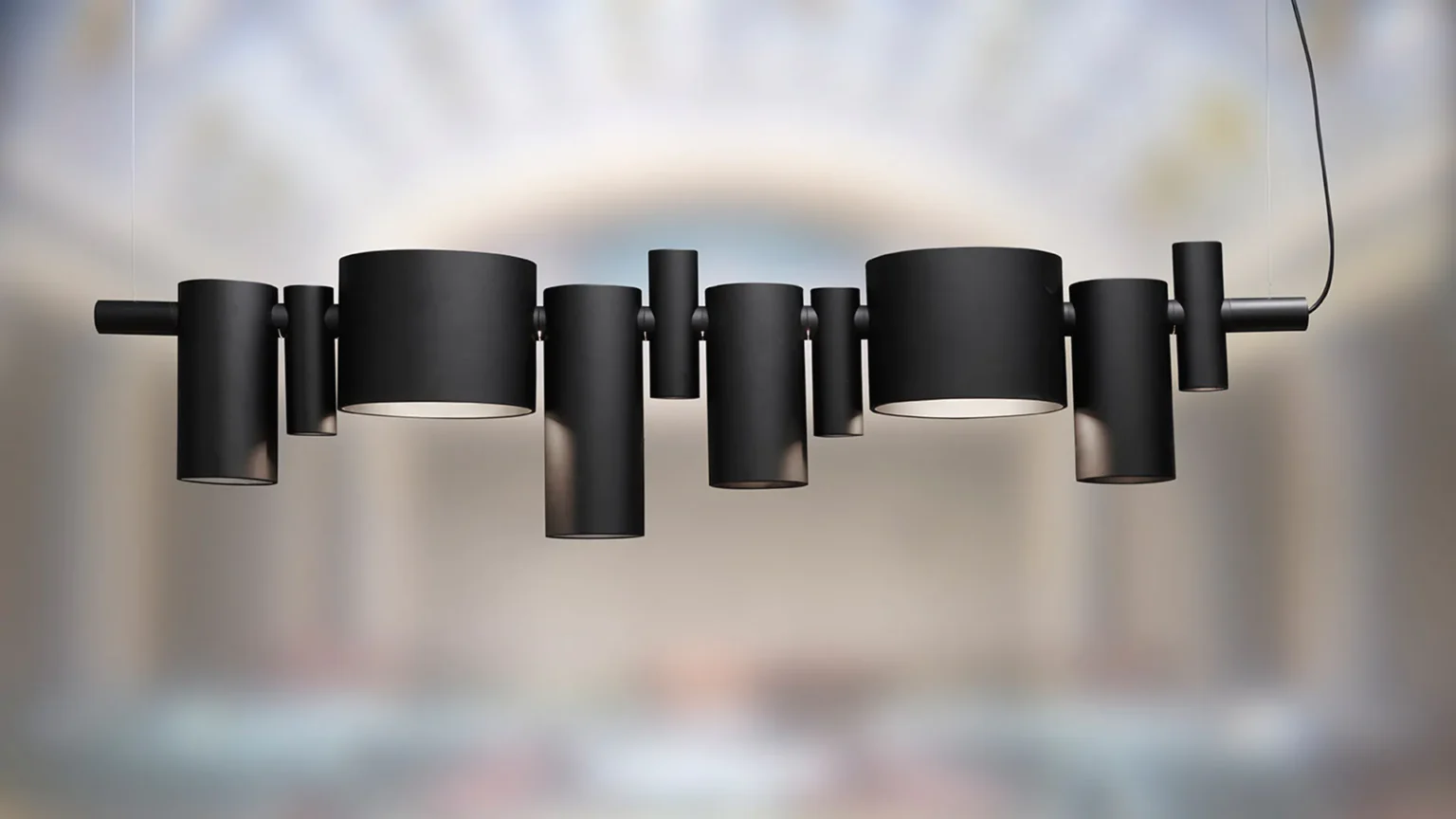 “Dancing Queen by Oluce contemporary designer lighting – elegant chandelier-style pendant with curved metal arms and minimalist silhouette”