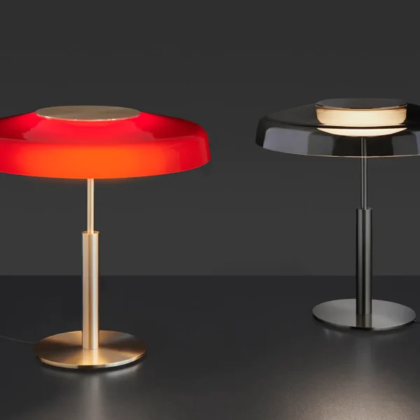 “Dora by Oluce stylish Italian lamp – sculptural table lamp featuring soft glowing diffuser and metal accents”