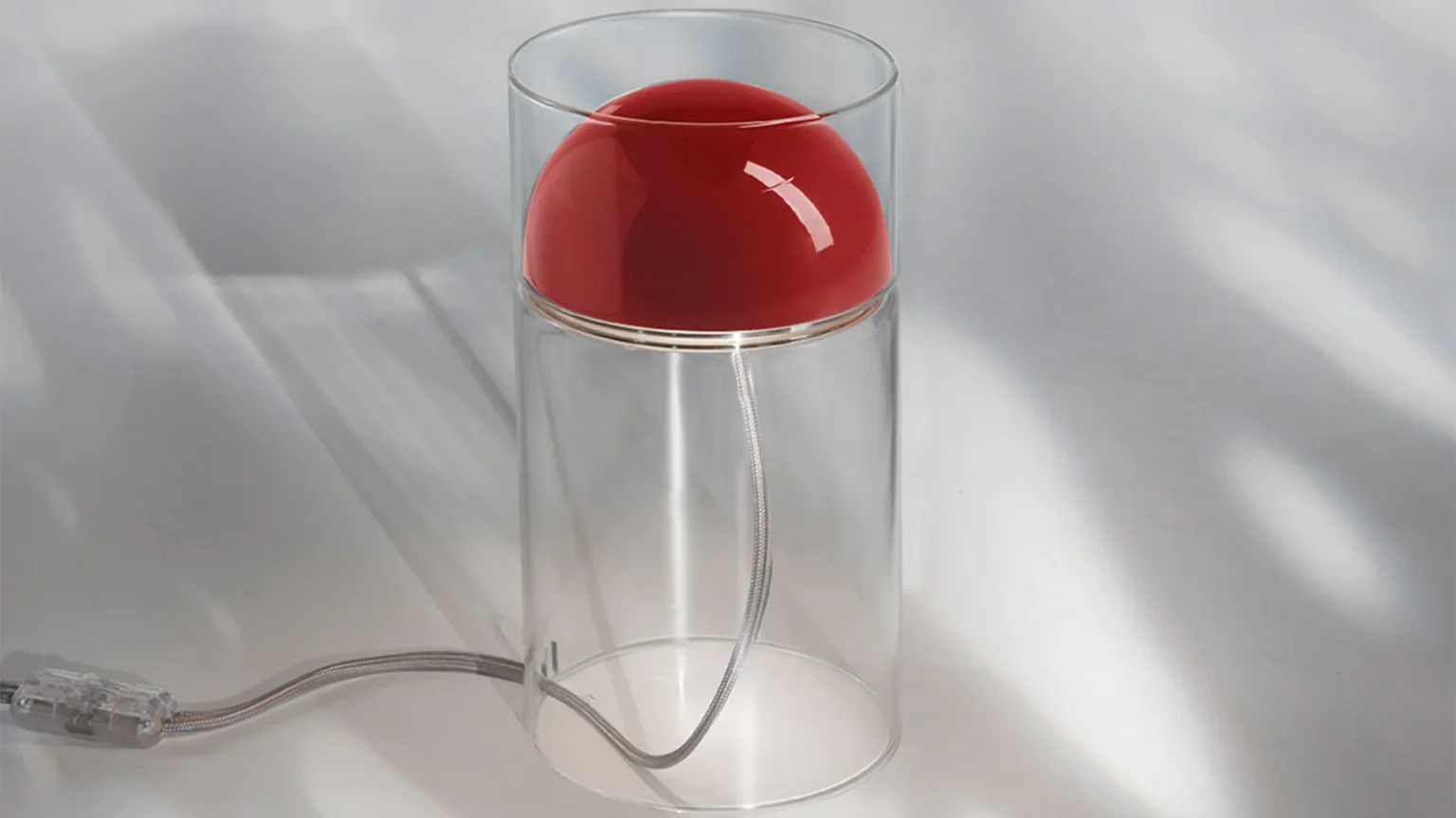 “Medusa by Oluce modern Italian table lamp – fluid glass form with glowing diffuser and sculptural elegance”